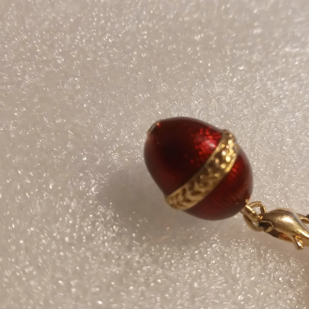 Faberge egg charm bracelet on a gold tone rolo chain. - Picture 11 of 16